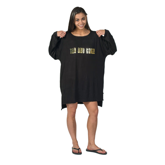 Woman wearing Tan and Chill Shirt, showcasing its relaxed fit ideal for post-tanning comfort. The design emphasizes casual fashion and comfort.